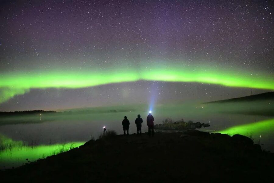 Aurora arc over a frozen lake outside Rovaniemi