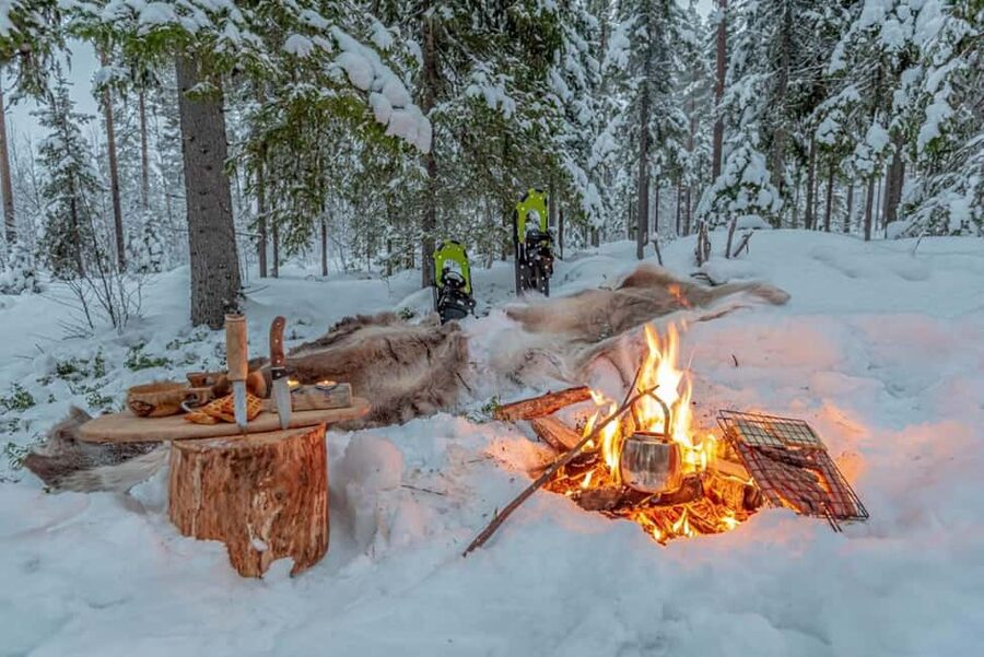 Snowshoe experience with traditional beverages in Lapland - Open-fire warm-up: hot drinks, local cheese, and sausages